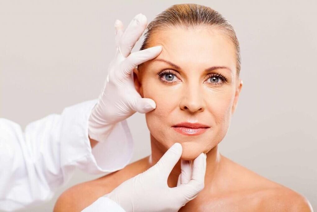 a doctor examines the skin before rejuvenation
